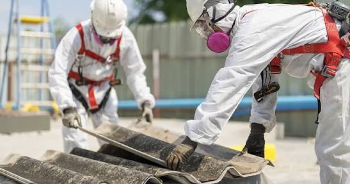 Certified Asbestos Roof Removal experts wearing protective equipment while safely removing an old asbestos roof in New Zealand.